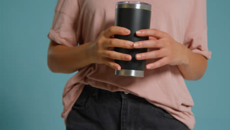 Close-Up-Shot-of-Young-Adult-Womans-Hands-Holding-Flask-02