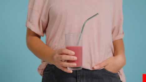 Close-Up-Shot-of-Young-Adult-Womans-Hands-Holding-Smoothie-01-