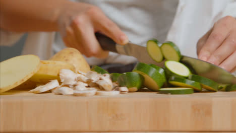 Tracking-Shot-of-Young-Adult-Woman-Slicing-Courgette-02