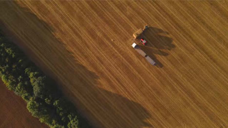 Drone-Shot-Looking-Down-On-Tractor-In-Rural-Field-