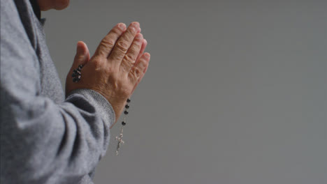 Close-Up-Shot-of-Senior-Mans-Hands-Holding-Some-Rosary-Beads-with-Copy-Space