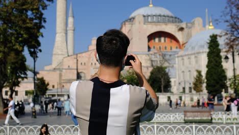 Medium-Shot-of-Young-Man-Taking-Photos-of-Hagia-Sophia