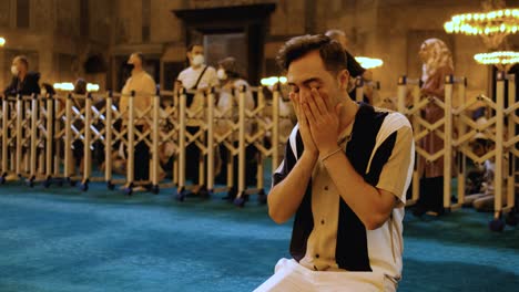 Medium-Shot-of-a-Young-Man-Praying-In-Hagia-Sophia-