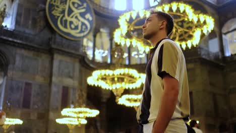 Low-Angle-Shot-of-Young-Man-eExamining-Interior-of-Hagia-Sophia