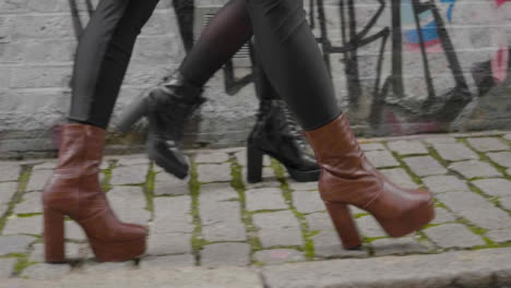 Tracking-Close-Up-of-Womens-Boots-Walking-on-Street