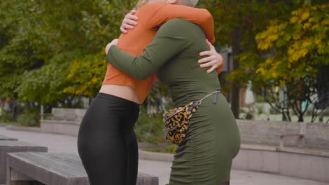 Mid-Section-of-Two-Young-Women-Embracing-and-Hugging-One-Another