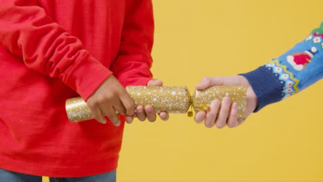 Close-Up-of-a-Christmas-Cracker-Being-Pulled