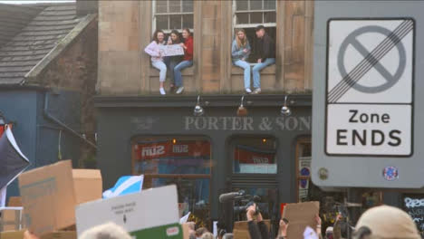 People-Sitting-in-Window-Supporting-March-at-COP-26-Protest-068
