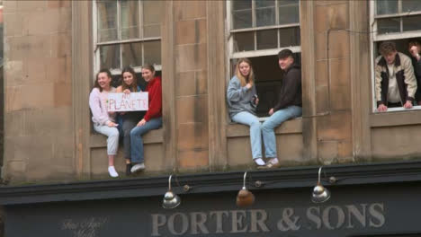 People-Sitting-in-Window-Supporting-March-at-COP-26-Protest-069