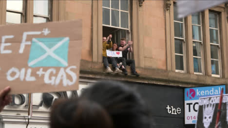 People-Sitting-in-Window-Supporting-March-at-COP-26-Protest-073