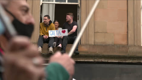 People-Sitting-in-Window-Supporting-March-at-COP-26-Protest-074