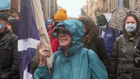 Handheld-Shot-of-Climate-Change-Protestors-Marching-Through-Streets-of-Glasgow