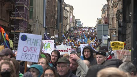 Handheld-Shot-of-Crowd-of-Climate-Change-Protestors-Marching-Through-Glasgow