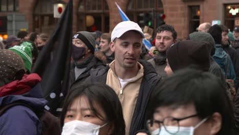 Handheld-Shot-of-Global-Warming-Protestors-Marching-Through-Streets-of-Glasgow