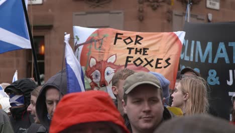 Handheld-Shot-of-Climate-Change-Activists-Marching-Through-Glasgow