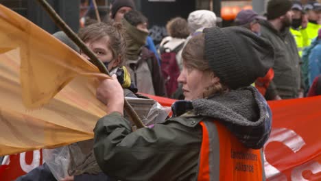 Handheld-Shot-of-Global-Warming-Activists-Walking-Through-Glasgow