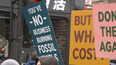 Handheld-Shot-of-Signs-Being-Held-Up-During-Global-Warming-Protests-In-Glasgow