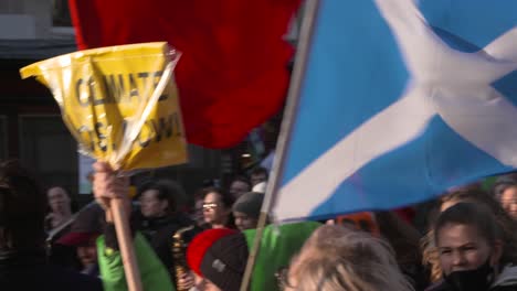 Handheld-Shot-of-Scottish-Flag-Flying-During-Climate-Change-Protests-In-Glasgow