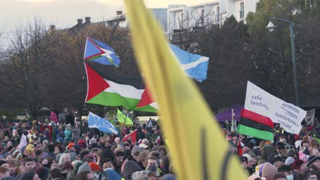 Handheld-Shot-of-Climate-Change-Protestors-Gathered-On-Glasgow-Green