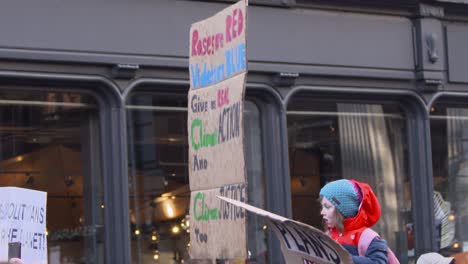 Handheld-Shot-of-Signs-Being-Held-Up-During-Climate-Change-Protests-In-Glasgow