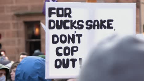 Handheld-Shot-of-Funny-Duck-Sign-During-Climate-Change-Protests-In-Glasgow