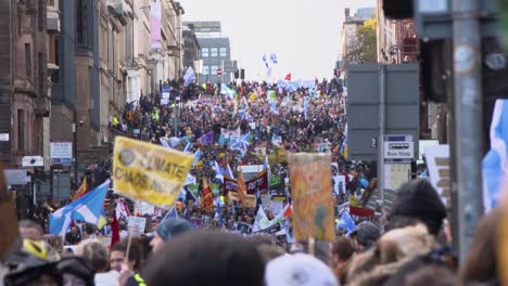Handheld-Shot-of-Crowd-of-Global-Warming-Protestors-Marching-Through-Glasgow