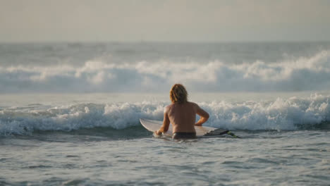 Long-Shot-of-Surfer-Swimming-Out-into-Ocean-in-Bali