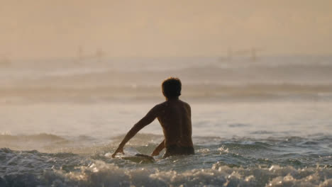 Long-Shot-of-Boats-in-Distance-and-Surfer-in-Ocean-in-Bali