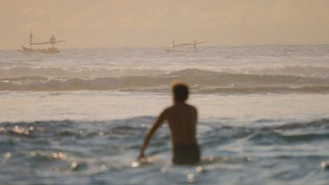 Long-Shot-of-Boats-in-the-Distance-and-Surfer-in-Ocean-in-Bali
