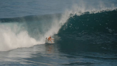 Long-Shot-of-Surfer-Being-Taken-By-Waves-in-Ocean-in-Bali
