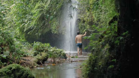 Totale-Aufnahme-Eines-Mannes,-Der-Auf-Bali-Durch-Das-Wasser-Geht