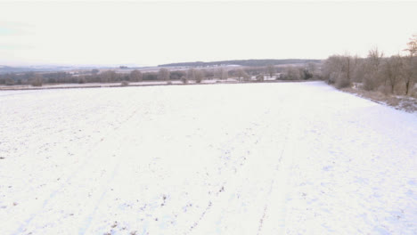 Drone-Shot-Flying-Over-Snow-Covered-Cotswold-Fields