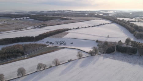 Drone-Shot-Flying-High-Over-Snowy-Cotswold-Fields
