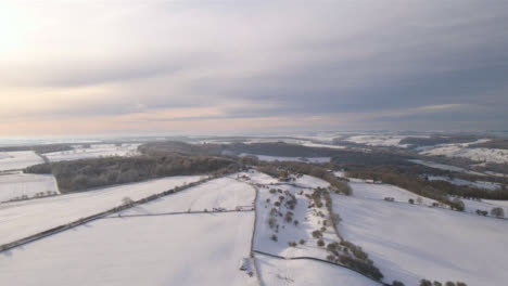 Drone-Shot-Approaching-Broadway-Tower-Surrounded-by-Snow