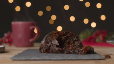 Close-Up-Shot-of-a-Christmas-Pudding-and-Hot-Mug-of-Coffee