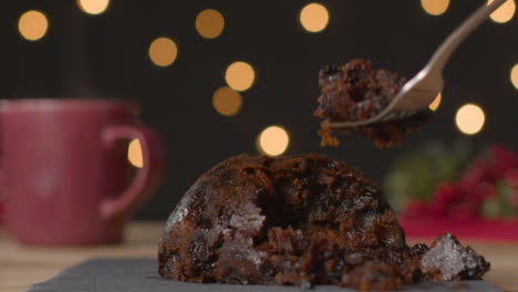 Close-Up-Shot-of-Christmas-Pudding-Being-Picked-at-with-Fork