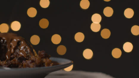 Close-Up-Shot-of-Rotating-Christmas-Pudding-Covered-In-Chocolate