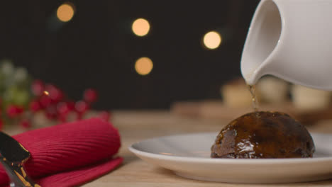 Close-Up-Shot-of-Alcohol-Being-Poured-On-Christmas-Pudding
