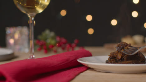 Sliding-Shot-of-Christmas-Pudding-On-a-Table-Being-Picked-with-Fork