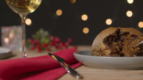 Sliding-Shot-of-Gold-Leaf-Christmas-Pudding-Being-Picked-with-Fork