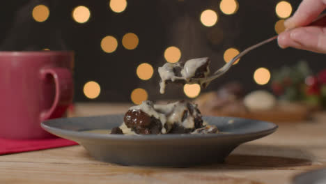 Close-Up-Shot-of-Hand-Using-Fork-to-Take-Piece-of-Chocolate-Christmas-Cake