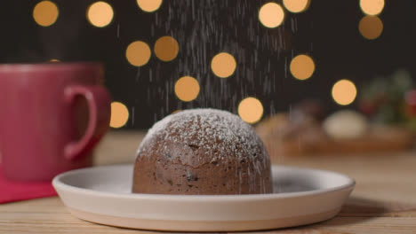 Sliding-Shot-of-a-Christmas-Pudding-On-Table