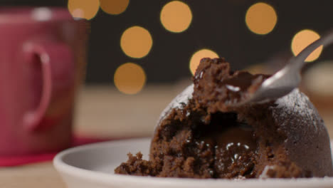 Close-Up-Shot-of-Fork-Taking-Piece-of-Christmas-Pudding