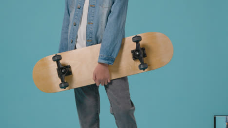 Mid-Shot-of-a-Child-Holding-Skateboard