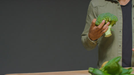 Portrait-Shot-of-Man-Picking-up-Broccoli-with-Copy-Space