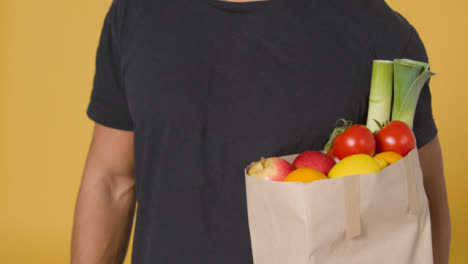 Close-Up-Shot-of-a-Man-Holding-Bag-of-Fruit-and-Vegetables