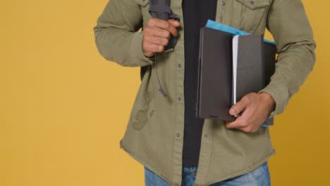 Close-Up-of-Man-Holding-Folder-and-Books