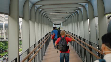 Tracking-Shot-of-Pedestrians-Walking-Along-Catwalk-