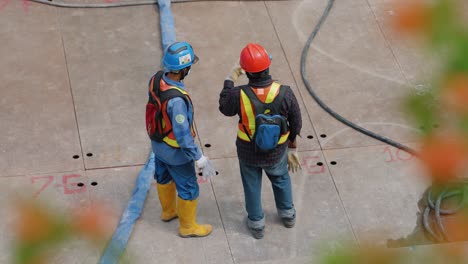 High-Angle-Shot-of-Two-Construction-Workers-Talking