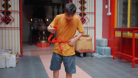 Tracking-Shot-of-Young-Boy-Tying-Fabric